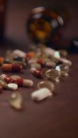 An Array of Different Assorted Pills and Capsules Beautifully Displayed on a Wooden Table Surface video
