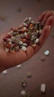 A Colorful Handful Featuring a Diverse Collection of Various Pills and Beautiful Stones video