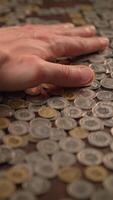 The image of a hand resting on a pile of coins symbolizes wealth and financial abundance video