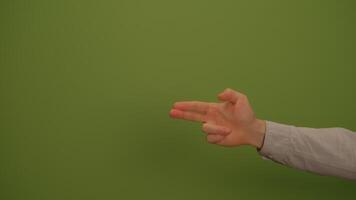 A hand gesture on a green background, showcasing artistic expression and modern communication video