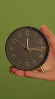 An Elegant and Modern Clock Beautifully Displayed Against a Vibrant and Lively Green Background video