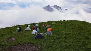Campground high in the mountains. Air clouds around. Drone view video