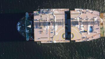 Aerial view of a transport ship carrying tanker sections. Top down view video