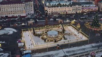 Aerial view of the central square with a skating rink and ice slides video