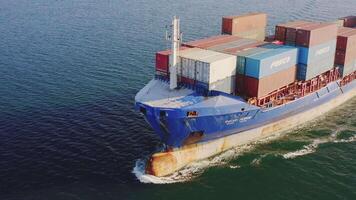 Aerial view of the bow of a container ship breaking waves video