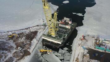Drone view of a floating crane that carries a truck from one coast to another video