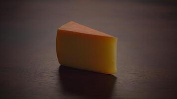 An Artistic Presentation of a Cheese Slice Displayed Against a Dark Background Setting video