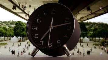 This is a stylish black alarm clock that features a scenic background, adding charm to any space video