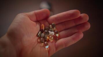A Collection of Various Assorted Supplements and Pills Held in Hand for Health Purposes video