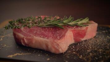 Delicious Fresh Meat with Herbs Featuring a Slate Background for an Appealing Presentation video