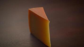 An Artistic Cheese Slice Displayed on a Dark Background, Creating a Beautiful Visual Appeal video