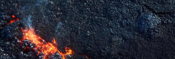 Molten lava flow on black rock surface capturing natural geological phenomenon photo