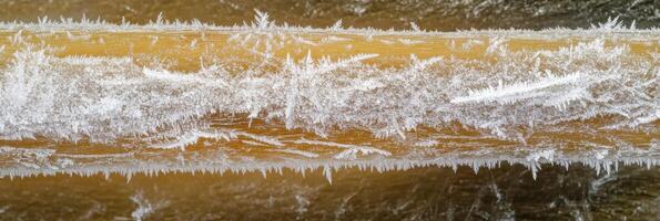Close-up of ice crystals on wooden surface capturing natural patterns in winter photo