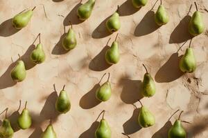 Fresh green pears arranged in symmetrical pattern with shadows on textured surface photo