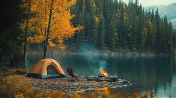 Scenic autumn forest campground with tent, campfire, and lake view in wilderness photo