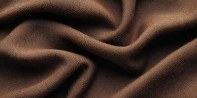 Close-up of smooth brown fabric with flowing folds for texture and surface background photo