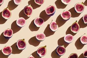 Fresh halved and whole figs pattern on light beige background for food concepts photo