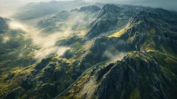 Misty mountain range with lush green valleys and enveloping fog from above photo