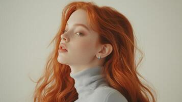 Portrait of a young woman with long red hair in a light blue turtleneck sweater photo