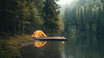 Tranquil camping by the lake in forest setting with tent and lantern reflections photo