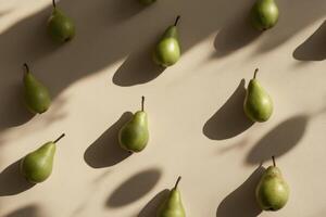 Fresh green pears arranged in artistic pattern with shadows on beige background photo