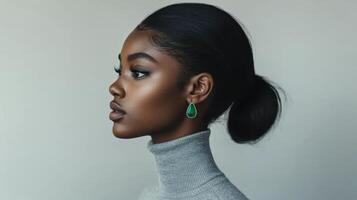 Elegant female profile with green earring showcasing minimalistic style and serene expression photo