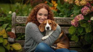 Smiling woman embracing beagle on wooden bench in garden setting photo