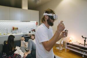 A Family Happily Enjoying Virtual Reality Games Together in the Comfort of Their Home photo