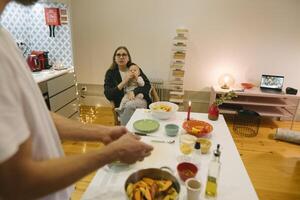 A Cozy Family Moment Enjoying Cooking Together with a Baby at Home in a Heartwarming Environment photo