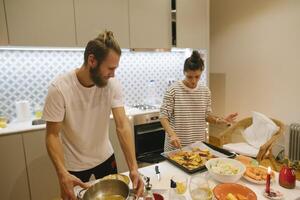 Engaging in the enjoyable activity of cooking together within a modern kitchen setting photo