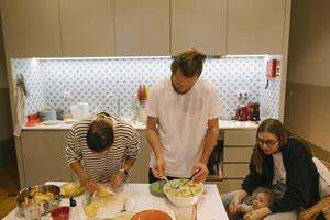 Enjoying Quality Time by Cooking Together as a Family in a Modern Kitchen Environment photo