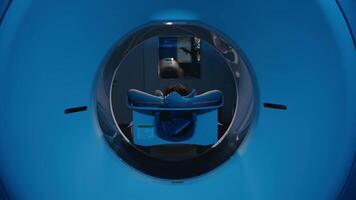 Anonymous Female Patient Lying on a CT, MRI Scan Bed Undergoes Scanning Procedure. Bed Moves Towards Camera. Precise diagnostics and internal organ visualization. Doctor preparing computed tomography video