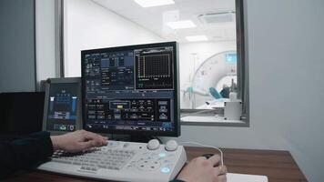 Radiologist Watching Diagnosis Procedure and Monitors on computer Showing Heart Scans Results, In the Background Patient Undergoes MRI or CT Scan Procedure video