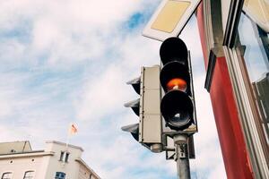 Red traffic nice light for pedestrians, semaphore background foggy autumn sky photo