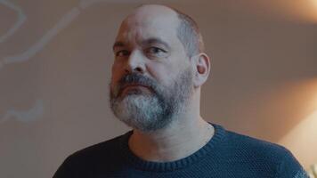 Man looking serious and frowning into camera lens video