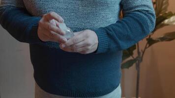 Man with face mask putting hand gel in palm rubbing hands video