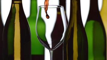 Red wine pouring in slow motion with bottles in background shot on Phantom Flex 4K at 1000 fps video