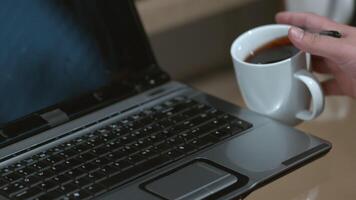 Spilling coffee on laptop computer slow motion video