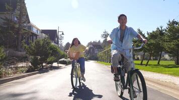 Couple riding bikes in coastal community video
