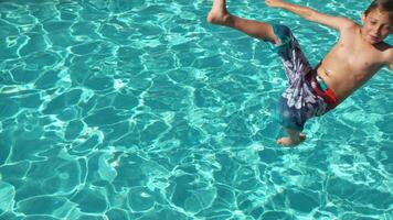 Boy splashing into pool in slow motion, shot on Phantom Flex 4K video