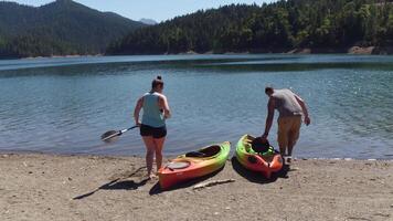 Couple getting ready to kayak at lake video