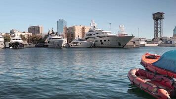 A boat is docked in a harbor with a city in the background video