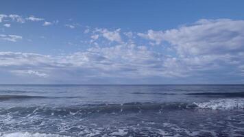 A beach with waves and a sky with clouds video