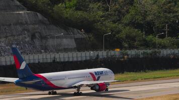 PHUKET, THAILAND FEBRUARY 07, 2023 - Boeing 767, RA 73078 of Azur Air taxiing at Phuket Airport. Airplane on the taxiway, side view. Footage of plane on the airfield. video