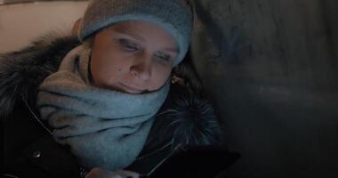 Woman passing time with mobile during night bus ride video