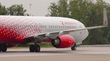 MOSCOW, RUSSIAN FEDERATION JULY 28, 2021 - Medium shot of Boeing 737 Rossiya taxiing at Sheremetyevo airport. Side view, plane on taxiway video