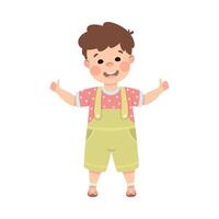 Cute cheerful little boy showing thumb up gesture with both hands. Happy brown haired boy dressed jumpsuit standing with open arms cartoon illustration vector