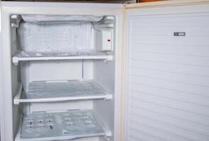 an ice crust has formed on the walls of the freezer and on the cooling tubes, and the ice is spreading, urgent defrosting is required, photo