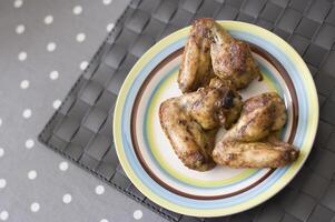 grilled chicken wings close up on the plate on the table, Meat food concept, photo