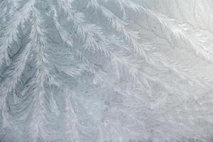 frost patterns on glass at subzero temperatures, abstract winter pattern,white lace pattern, photo